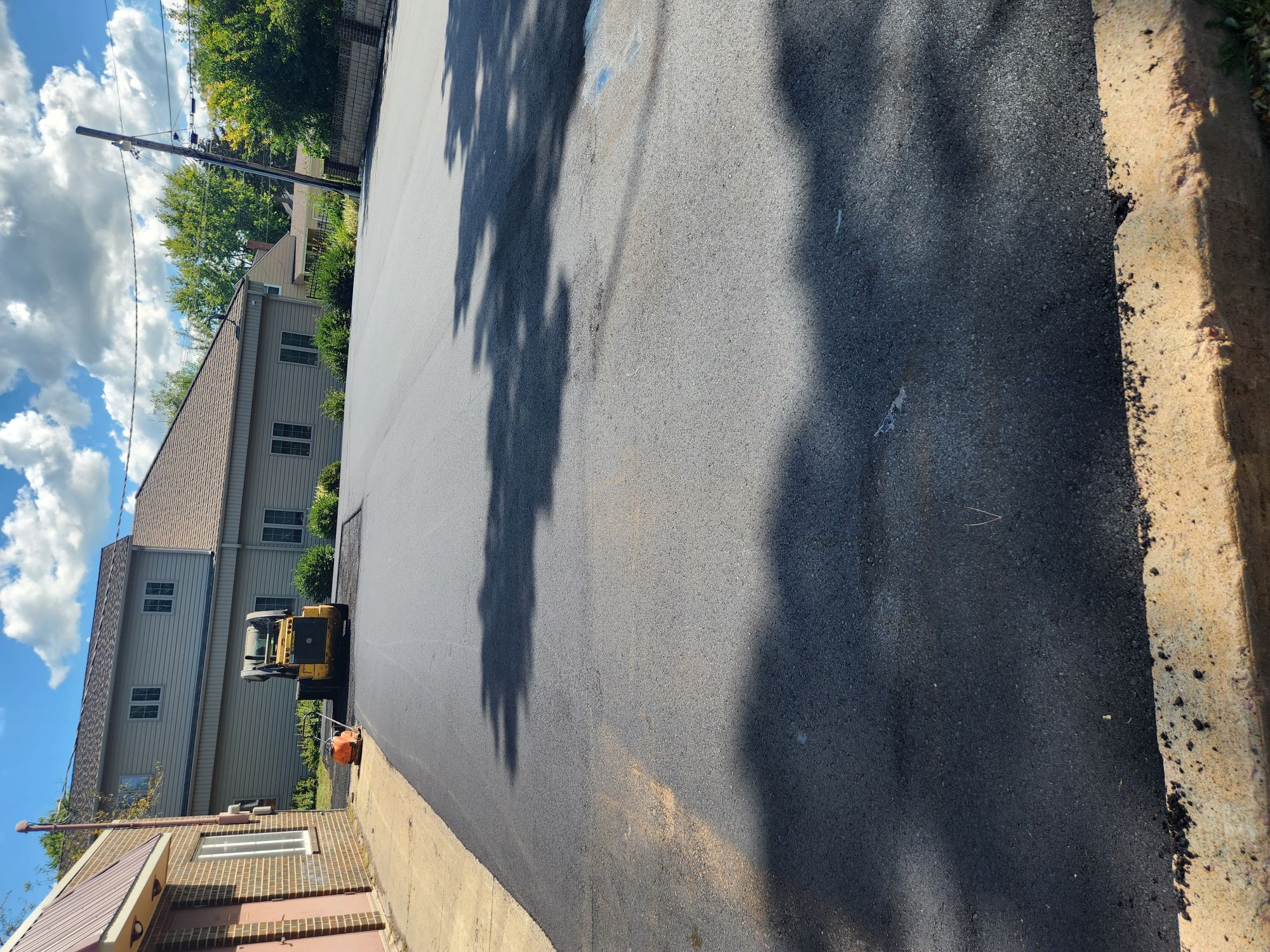 Fresh asphalt being laid on a project